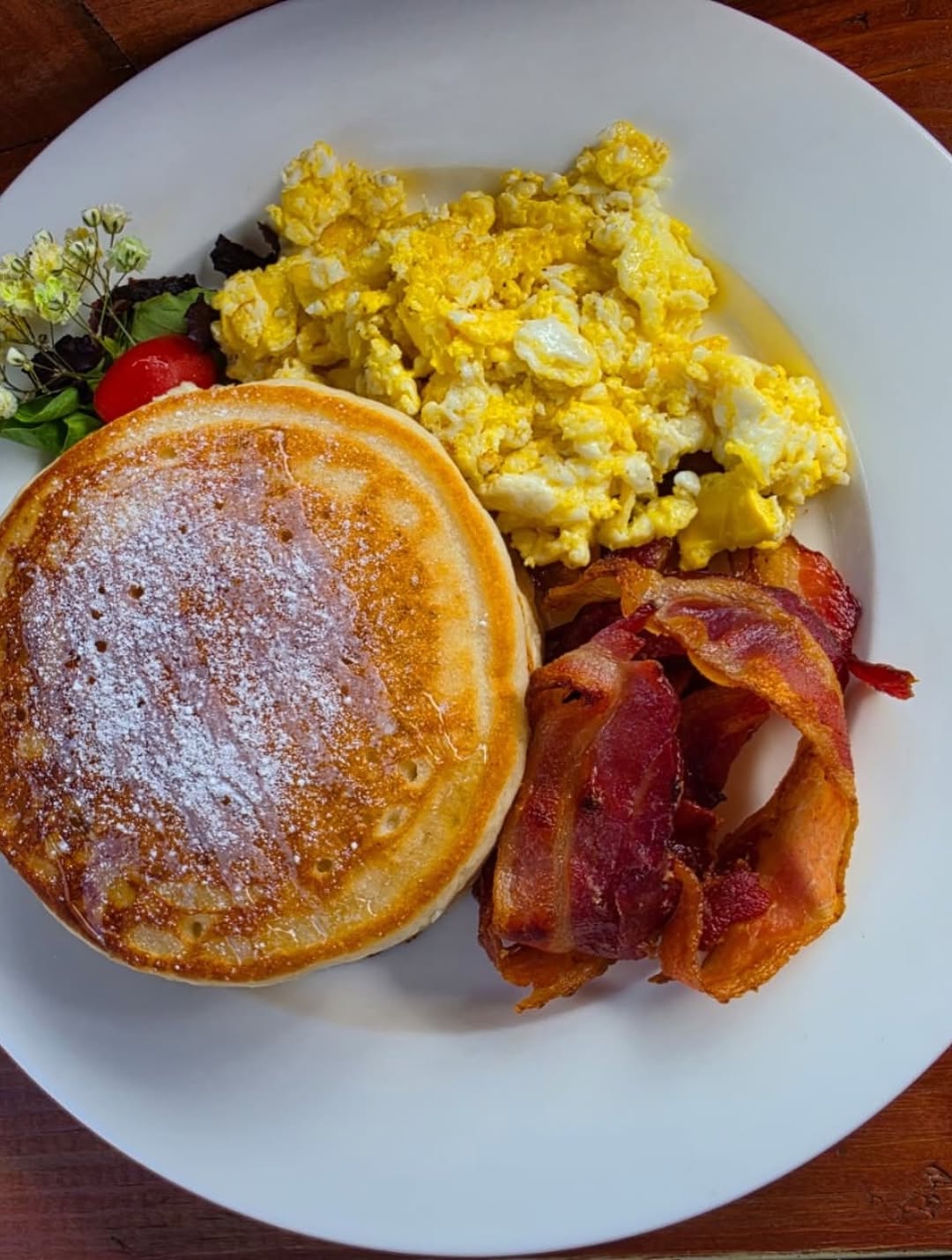 Pancakes, eggs, and bacon plate